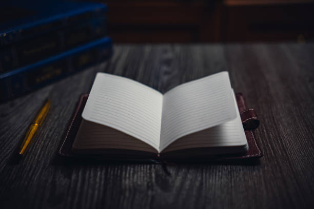istock A notebook with a gold pen on the table in the candlelight 2154517827