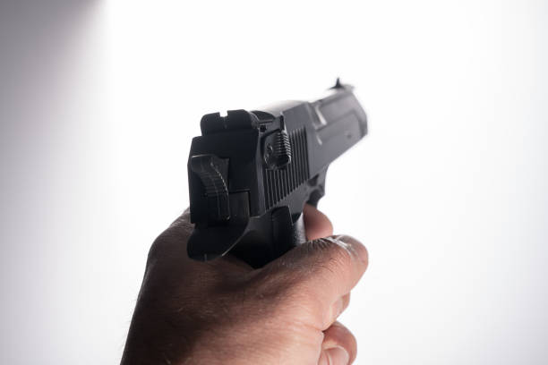 Police officer aiming a handgun towards the camera.