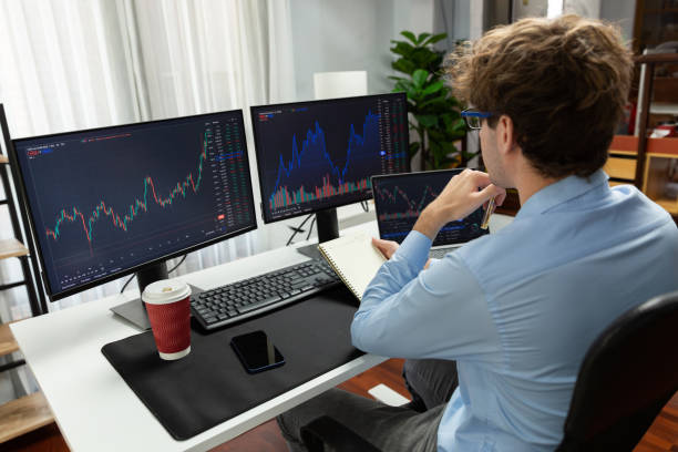 istock Working trader looking on laptop on screens, holding notepad and pen. Gusher. 2154519776