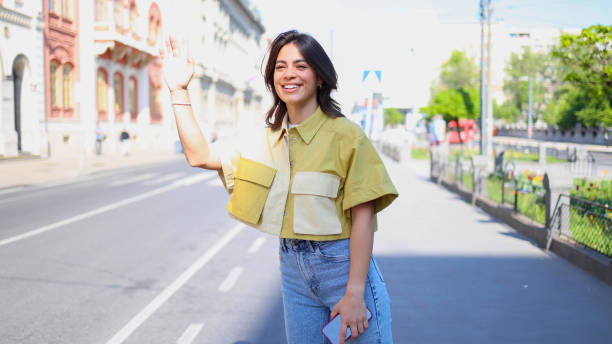 istock Latin young woman calling a cab 2154519815