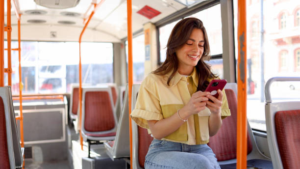 istock Happy Mexican woman having fun online while riding in a bus 2154519910
