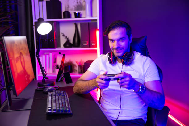 istock Smart gaming streamer with joystick looking camera with shooting game. Surmise. 2154520123