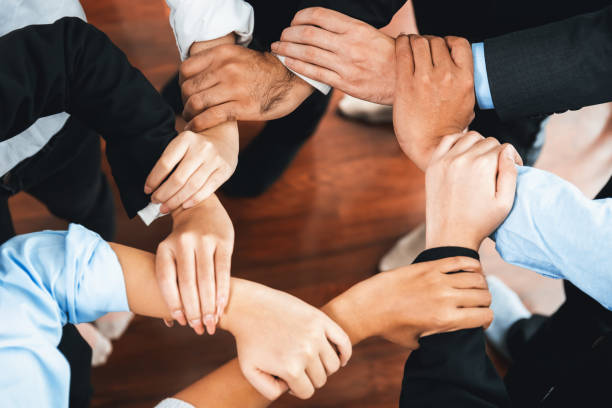 istock Multicultural business people holding hand together in circle. Habiliment 2154521172