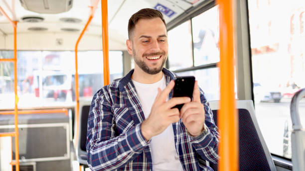 istock Young man in a bus surfing the net 2154521333