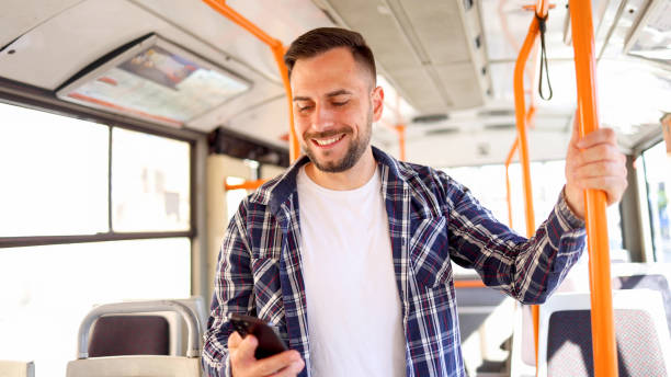 istock Young man in a bus surfing the net 2154521334