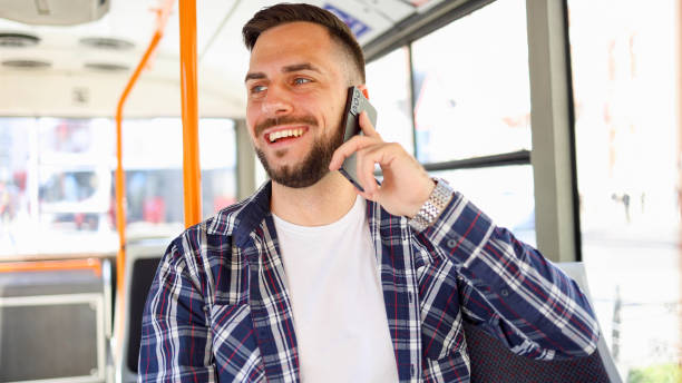 istock Young man in a bus chatting on mobile phone 2154521380