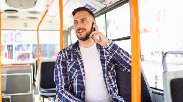 istock Young man in a bus chatting on mobile phone 2154521381