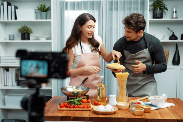 istock Chef influencers cooking special spaghetti with tongs to fried pan. Postulate. 2154521492