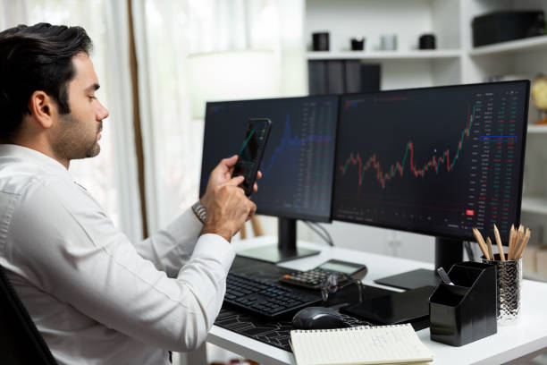 istock Trader businessman searching on smartphone, analyzing in dynamic stock. Surmise. 2154523088