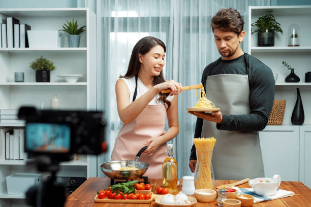 istock Chef influencers cooking special spaghetti with tongs to fried pan. Postulate. 2154523723