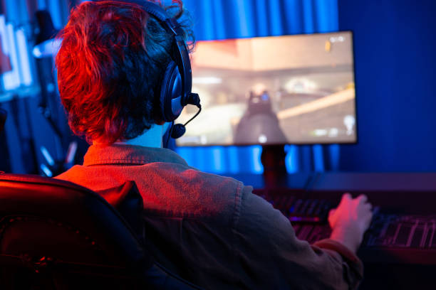 istock Gaming streamer team playing battle game shooting at back side image. Gusher. 2154523837