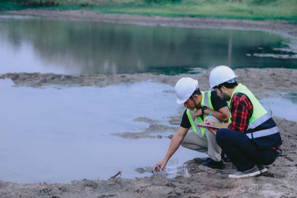istock Environmental engineers work at wastewater treatment plants,Water supply engineering working at Water recycling plant for reuse,Technicians and engineers discuss work together 2154525681