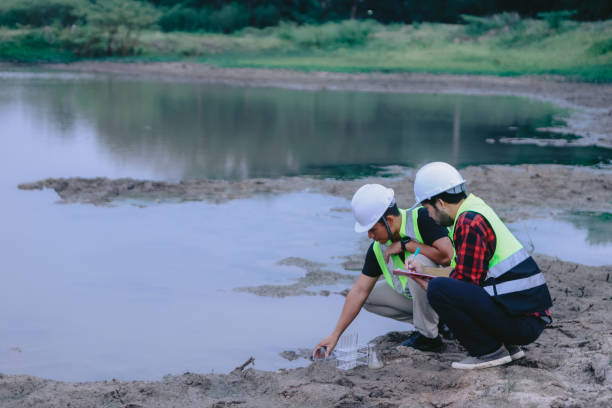 istock Environmental engineers work at wastewater treatment plants,Water supply engineering working at Water recycling plant for reuse,Technicians and engineers discuss work together 2154525684