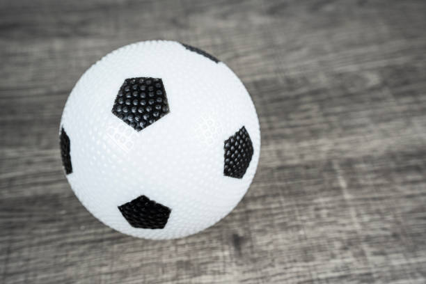 Soccer Ball On A Grey Wooden Table