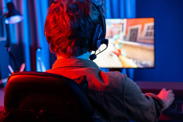 istock Gaming streamer team playing battle game shooting at back side image. Gusher. 2154527891