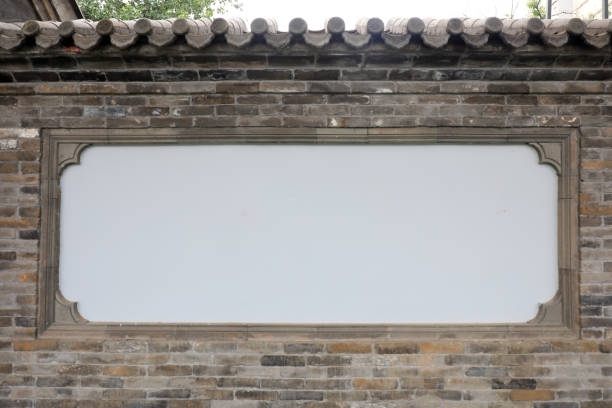 Various shapes of windows on the red wall
