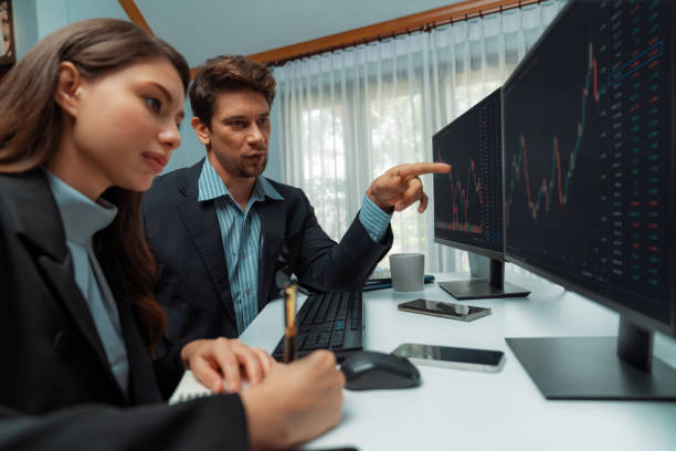 istock Two business traders consulting stock market, coworker taking note. Postulate. 2154530566