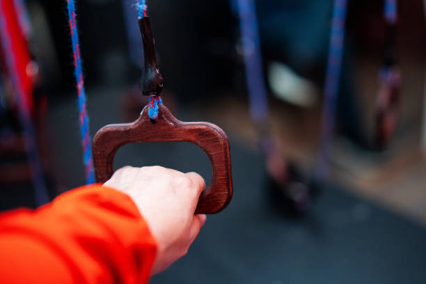 Close up of a hand gripping a backpack strap against a green background, capturing texture, strength, and daily functionality. Perfect for travel, lifestyle, and utility visuals