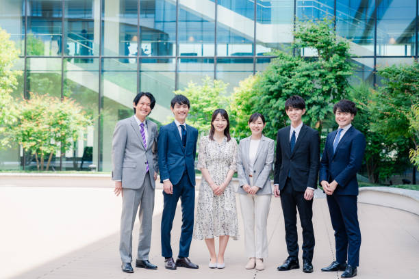 Young Employee Team Smiling in Front of Office Building