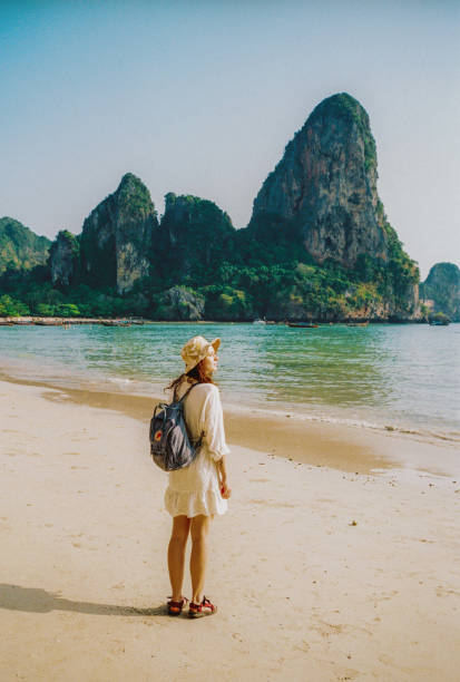 istock Woman walking on Railey beach and looking at stunning scenery 2154536045