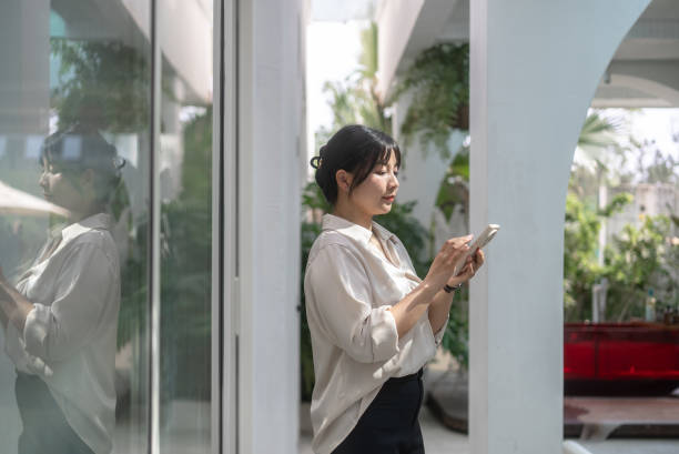 istock business woman using mobile phone 2154536146