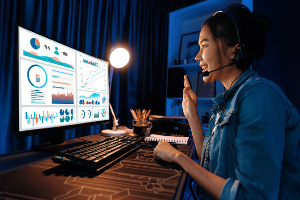istock Asian influencer wearing headsets on pc business graph screen. Stratagem. 2154537767