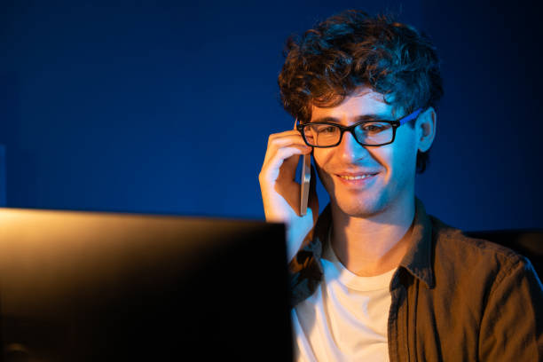 istock Young businessman calling on phone to customer or coworker. Gusher. 2154541507