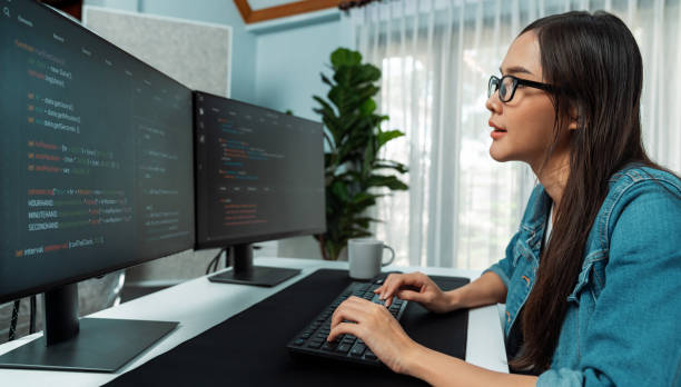 istock Young Asian in IT creating with typing online information on pc. Stratagem. 2154543819