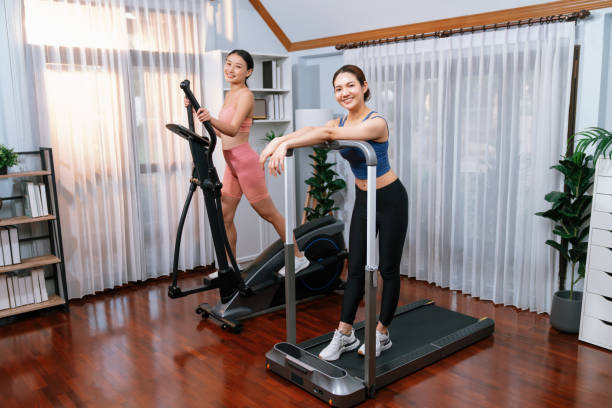 istock Energetic and strong athletic asian woman running on machine. Vigorous 2154544352