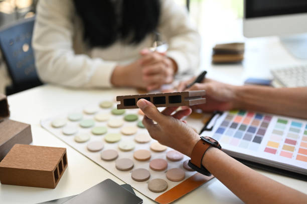 istock Interior designers working with furniture material samples at co working space in office 2154546515