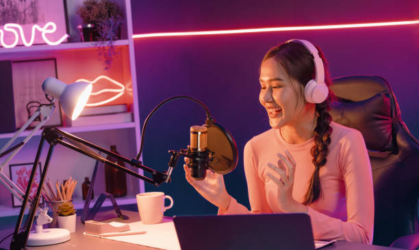 istock Smiling creative young beautiful Asian influencer talking in channel. Stratagem. 2154546816