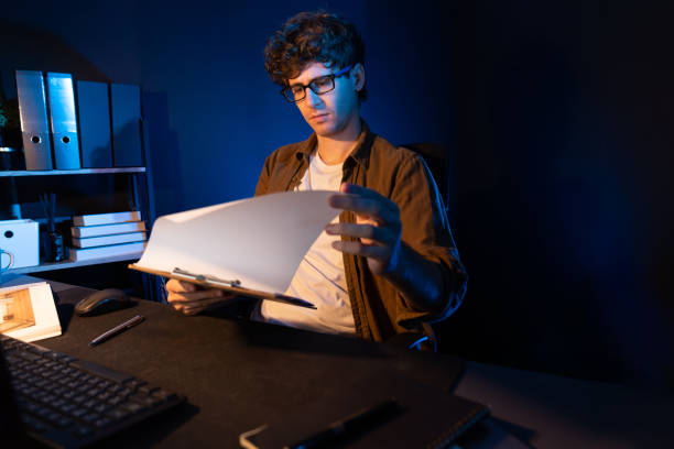 istock Young businessman reading design thinking on paper for new project. Gusher. 2154547919