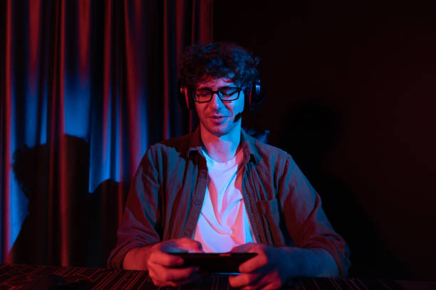 istock Smiling streamer team playing with Esport online on smartphone. Gusher. 2154548112