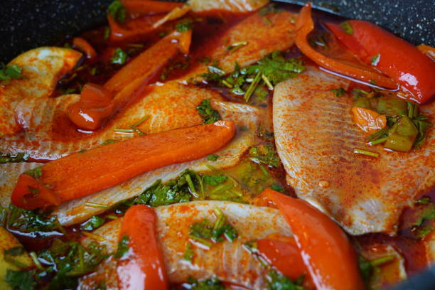 istock Moroccan fish  with chermoula, red peppers and preserved lemon cooking process. Spicy traditional  Moroccan food 2154549371