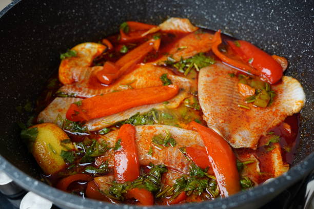 istock Moroccan fish  with chermoula, red peppers and preserved lemon cooking process. Spicy traditional  Moroccan food 2154549432