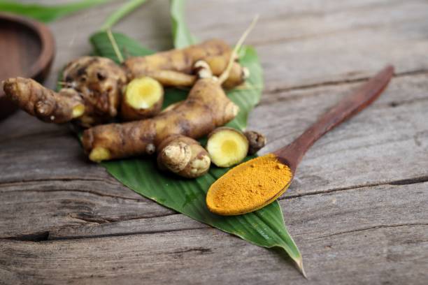 istock Turmeric root powder on wood background 2154549541