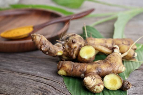 istock Turmeric root powder on wood background 2154549542