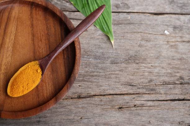istock Turmeric root powder on wood background 2154549554