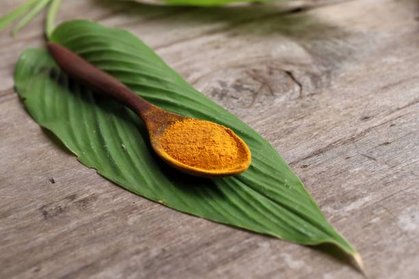 istock Turmeric root powder on wood background 2154549611