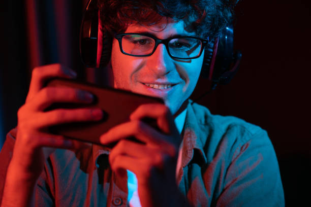 istock Smiling streamer team playing with Esport online on smartphone. Gusher. 2154551742