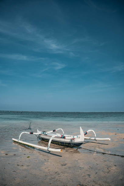 A traditional boat known as a jukung with a counterweight At karang beach in Sanur. taken during the day