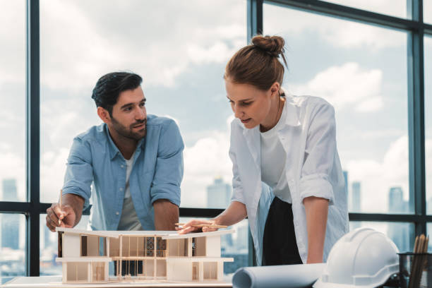 istock Smart architect engineer team working together to measure house model. Tracery. 2154552365