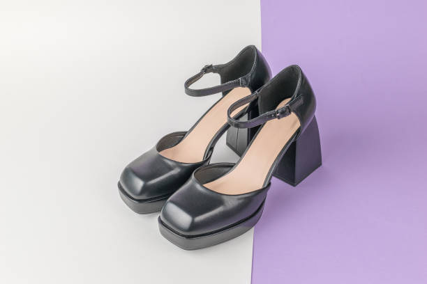 istock Black Chunky Heel Ankle Strap Shoes on Dual-Tone Background 2154552933