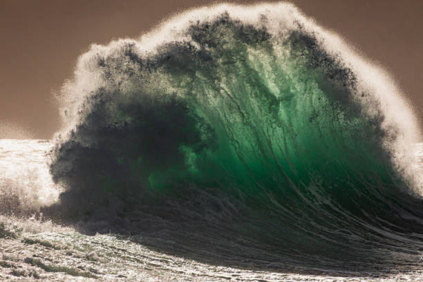 istock Colliding waves creating a dramatic display of power in nature with golden light 2154555424