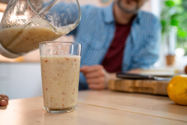 istock An unrecognizable man pouring freshly-blended fruit smoothie into a drinking glass 2154555439