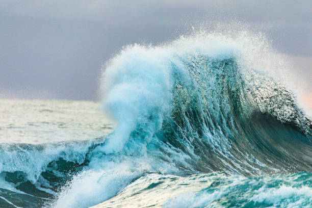 istock Colliding waves creating a dramatic display of power in nature with golden light 2154555580