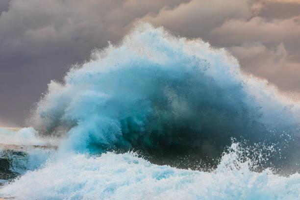 istock Colliding waves creating a dramatic display of power in nature with golden light 2154555608