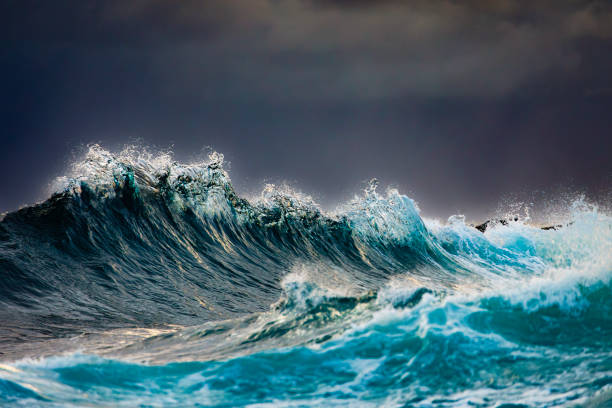 istock Colliding waves creating a unique water formation in nature with golden light 2154555688