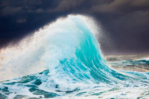 istock Colliding waves creating a unique water formation in nature with golden light 2154555744
