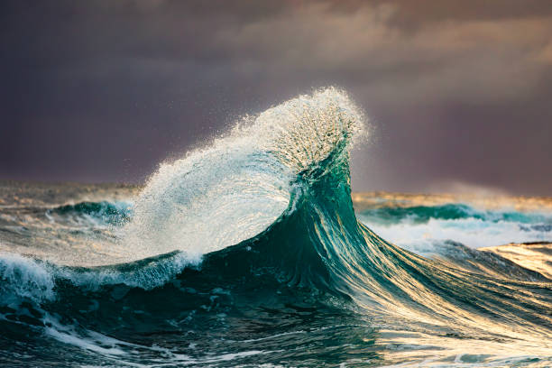 istock Colliding waves creating a unique water formation in nature with golden light 2154555784